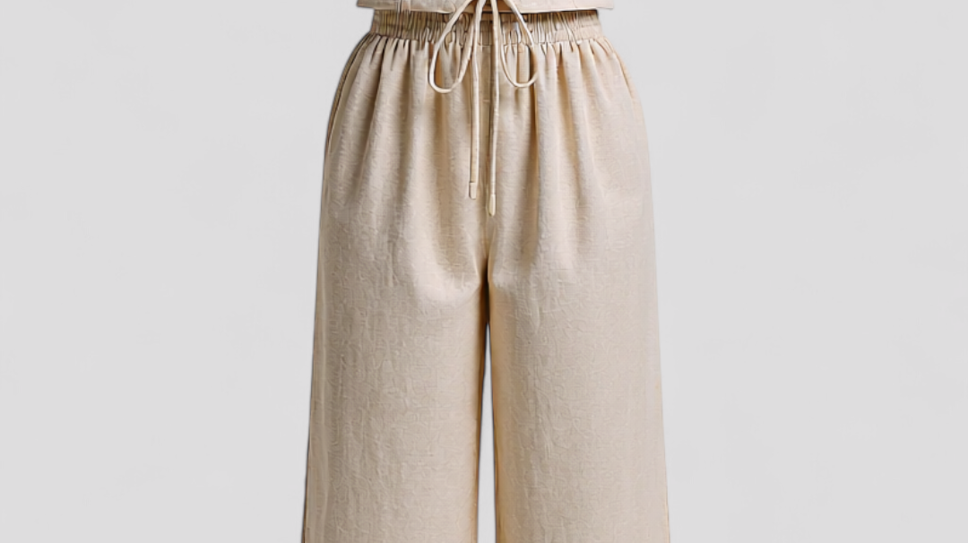 Woman wearing an elegant beige linen two piece set for summer 2026